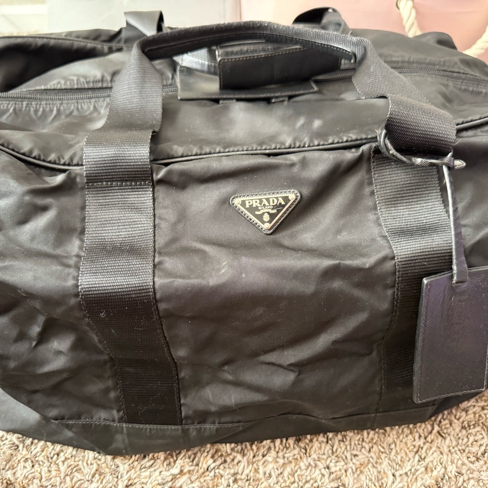 Prada Black Duffel Bag with Cylindrical Shape and Reinforced Handles